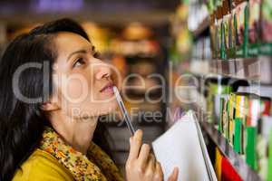 Thoughtful woman shopping for grocery
