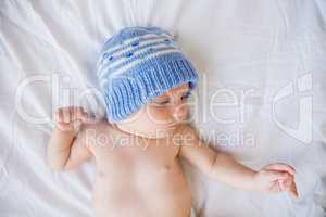 Cute baby boy relaxing on bed