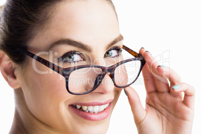 Portrait of beautiful woman posing with spectacles against white background