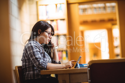 Female student using digital tablet