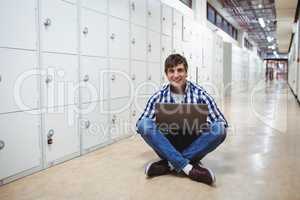 Student using laptop in locker room