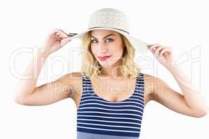 Portrait of beautiful woman posing with hat against white background