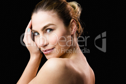 Portrait of beautiful woman posing against black background