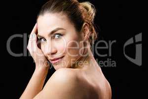 Portrait of beautiful woman posing against black background