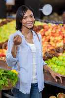 Smiling woman buying fruits in organic section
