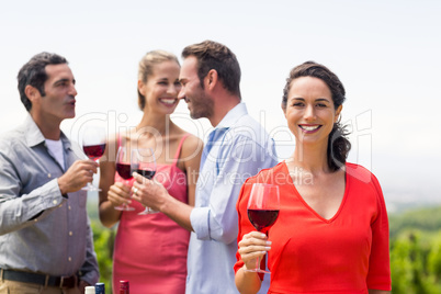 Woman holding wine glass smiling at camera