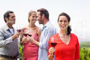 Woman holding wine glass smiling at camera