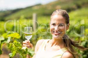 Portrait of female vintner holding wine glass