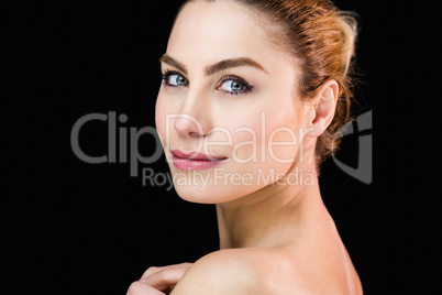 Portrait of beautiful woman posing against black background