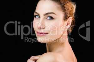 Portrait of beautiful woman posing against black background