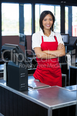 Female staff standing at cash counter