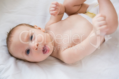 Portrait of baby boy relaxing on bed