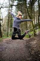 Beautiful woman jumping in forest