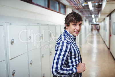 Portrait of student standing in locker room