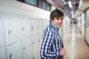 Portrait of student standing in locker room