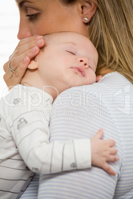 Mother holding and embracing her baby boy