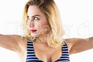 Beautiful woman posing with arms outstretched against white background
