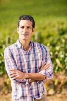 Portrait of male vintner standing with arms crossed