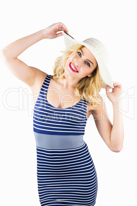 Portrait of beautiful woman posing with hat against white background