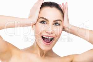 portrait of woman posing with shocked expression against white background