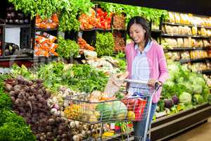 Woman buying vegetables in organic section