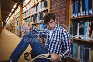 Student reading book in college library