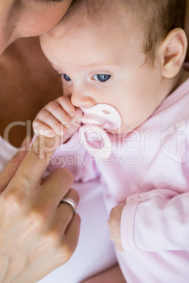 Mother playing with her baby in bedroom