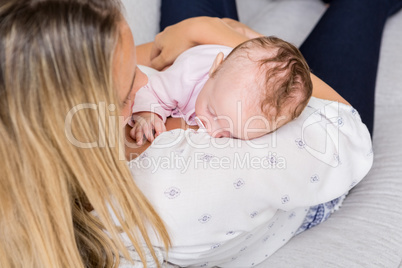 Mother carrying her baby in living room