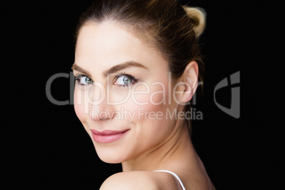 Portrait of beautiful woman posing against black background