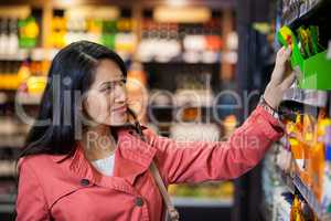 Woman selecting packages from grocery section