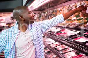 Man looking at goods in grocery section while shopping
