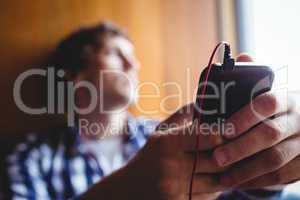 Upset student looking through window and listening music