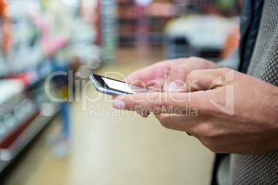 Hands of man using mobile phone