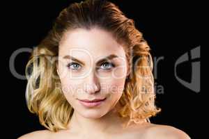 Portrait of beautiful woman posing against black background