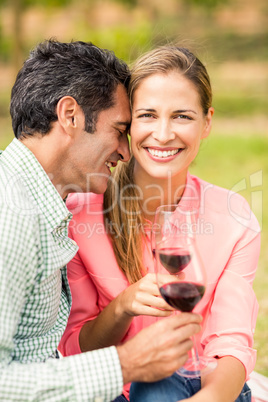 Happy couple holding glasses of wine