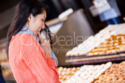 Excited woman selecting doughnuts