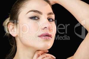 Portrait of beautiful woman posing against black background