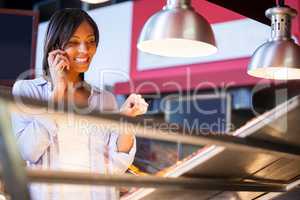 Excited woman talking on mobile phone
