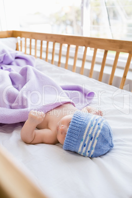 Baby lying on baby bed