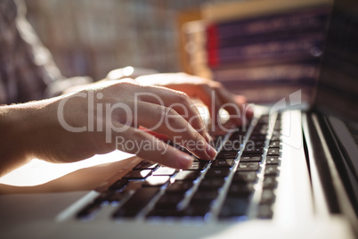 Female student using laptop in library