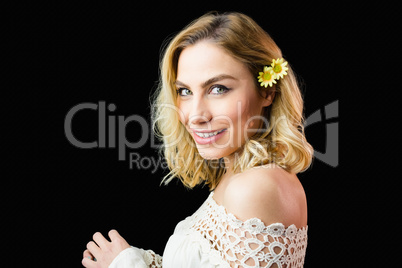 Portrait of beautiful smiling woman against black background