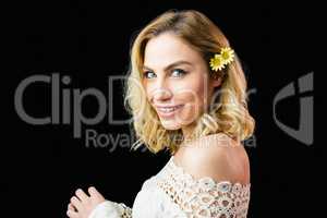 Portrait of beautiful smiling woman against black background