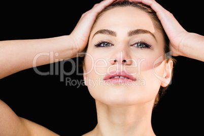 Portrait of beautiful woman posing against black background