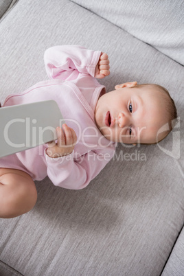 Baby lying on sofa in living room