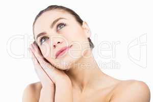 Thoughtful woman posing against white background