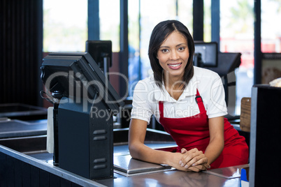 Female staff sitting at cash counter