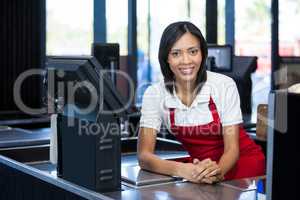 Female staff sitting at cash counter