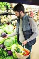 Man buying vegetables in organic shop