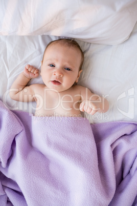 Portrait of baby boy relaxing on bed