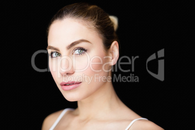 Portrait of beautiful woman posing against black background